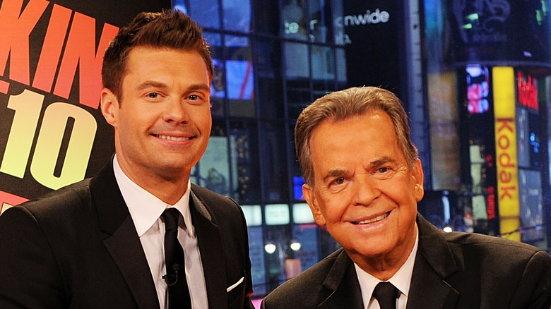 Ryan Seacrest and Dick Clark smile 