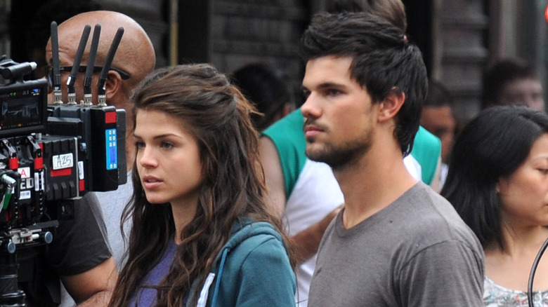 Taylor Lautner and Marie Avgeropoulos on set