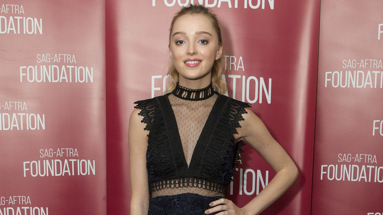 Phoebe Dynevor posing at event