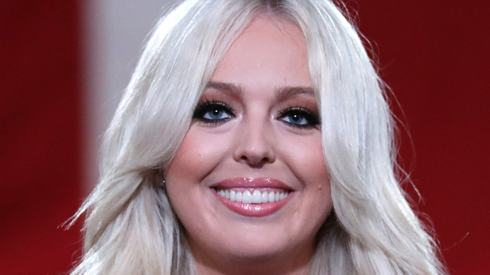 Tiffany Trump smiling with red background