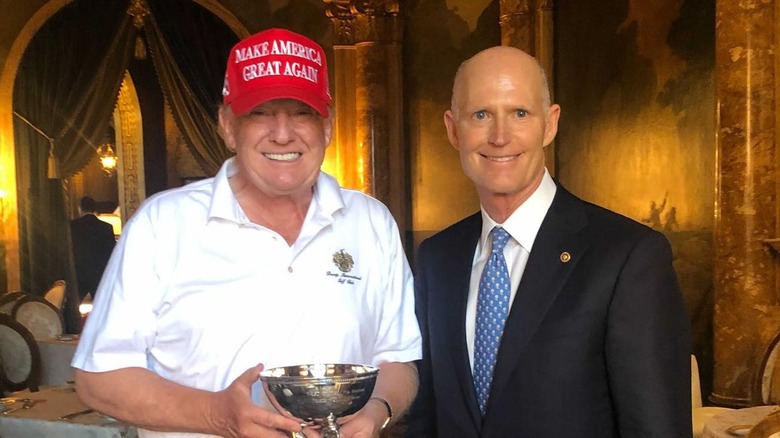 Donald Trump posing next to Rick Scott