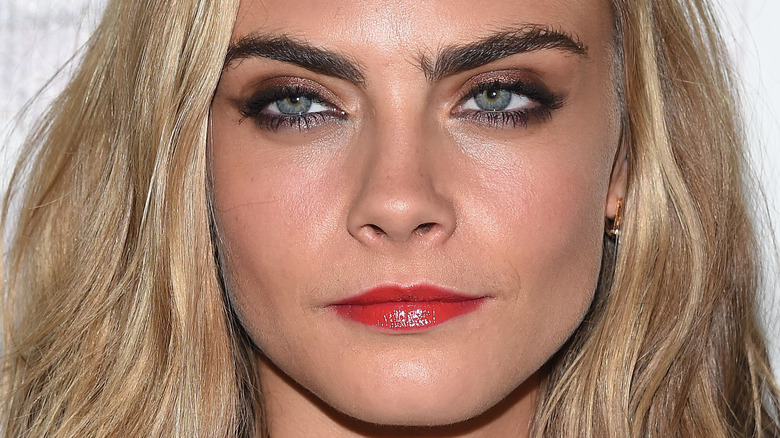 Cara Delevingne with a neutral expression