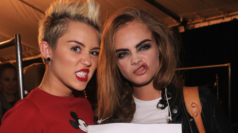 Miley Cyrus and Cara Delevingne pulling faces
