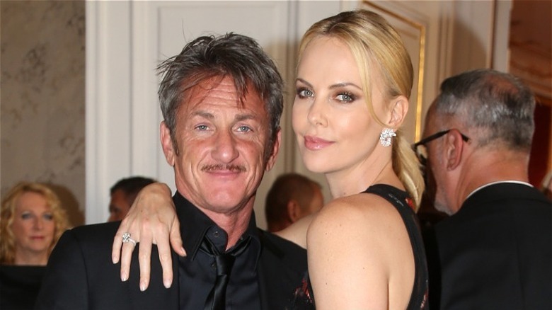 Charlize Theron with her arm around Sean Penn