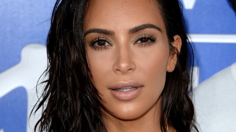 Kim Kardashian looks on
