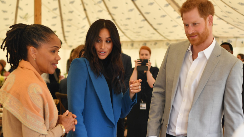 Doria Ragland, Meghan Markle, and Prince Harry chatting