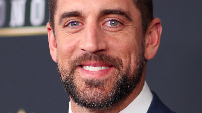 Aaron Rodgers smiling on the red carpet