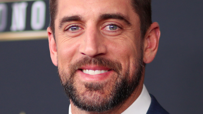 Aaron Rodgers smiling in suit