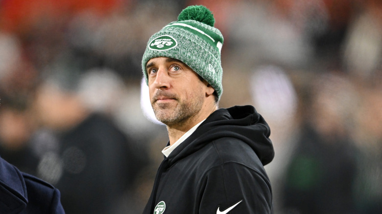 Aaron Rodgers wearing a green hat