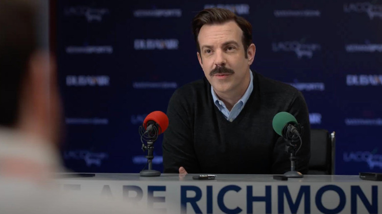 Ted Lasso at a press conference in the pilot episode