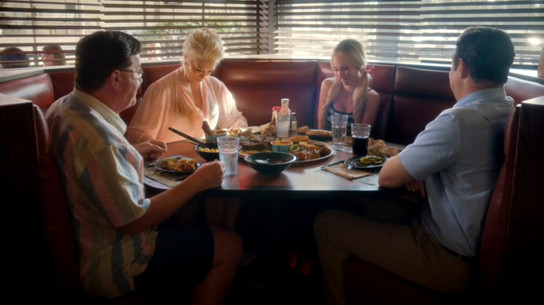 Higgins (Jeremy Swift), Rebecca (Hannah Waddingham), Keeley (Juno Temple), and Ted (Jason Sudeikis) eat lunch in Ted Lasso episode Home