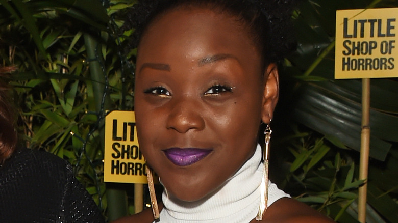 Seyi Omooba smiling purple lipstick