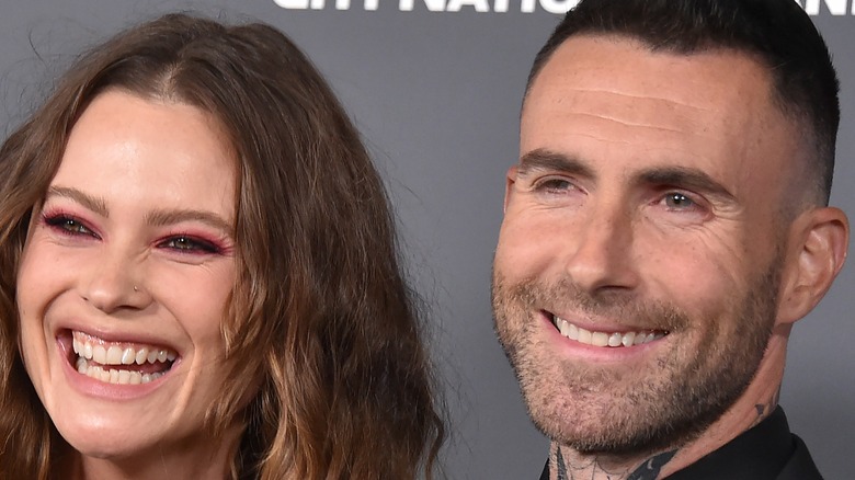 Behati Prinsloo and Adam Levine smiling