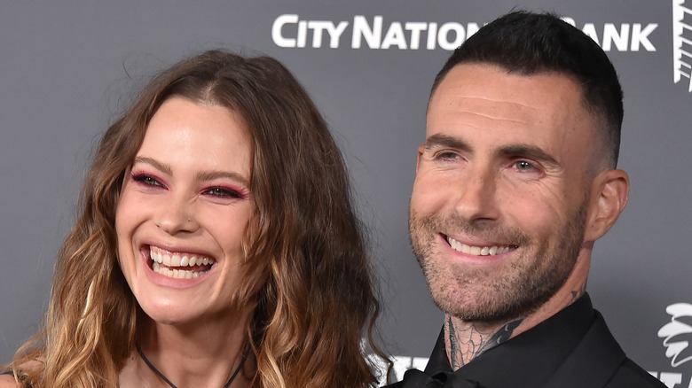 Behati Prinsloo and Adam Levine smiling