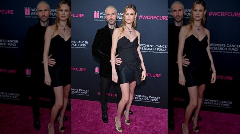 Adam Levine and Behati Prinsloo pose awkwardly in all black in 2023.