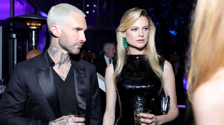 Adam Levine and Behati Prinsloo looking upset at 2023 Vanity Fair Oscar Party.