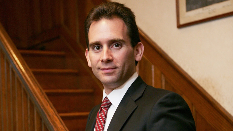 Adam Levy posing on a staircase.