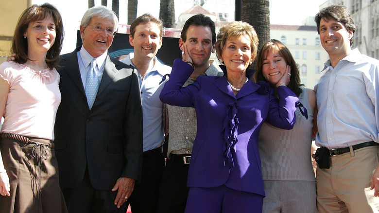 Judge Judy Sheindlin smiling with her family on the Hollywood Walk of Fame.