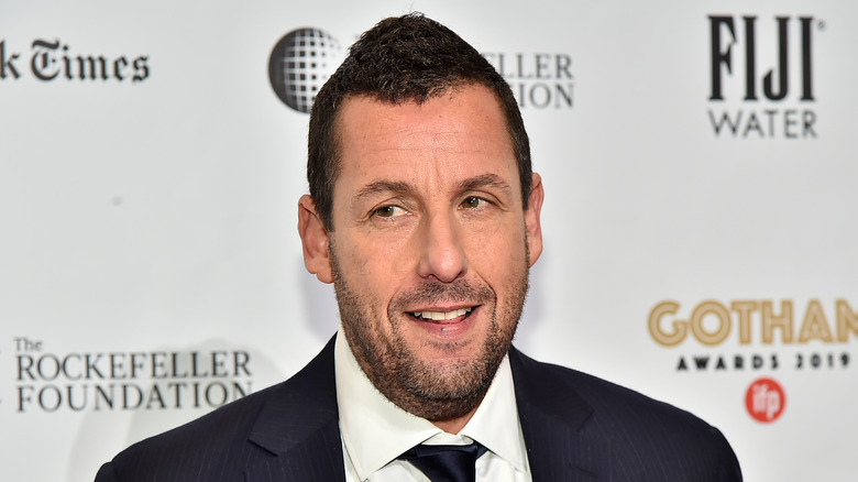 Adam Sandler poses in a suit