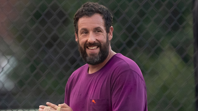 Adam Sandler smiling outside