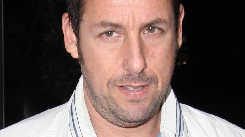 Adam Sandler in a white jacket