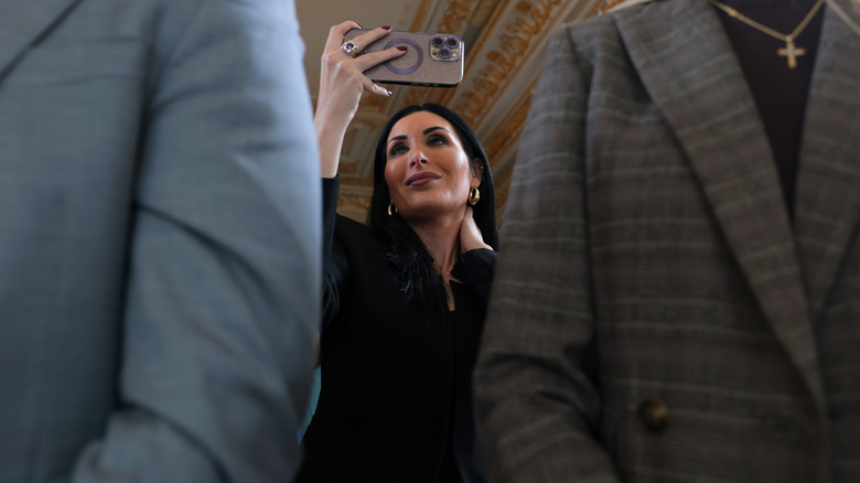 Laura Loomer taking a picture at Donald Trump's road naming ceremony.