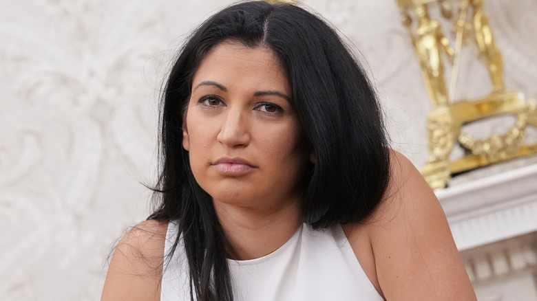 Katie Miller wearing a white shirt