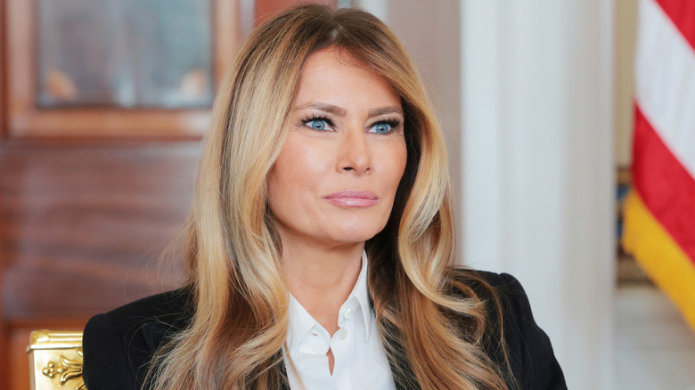 Melania Trump staring with a slight smile