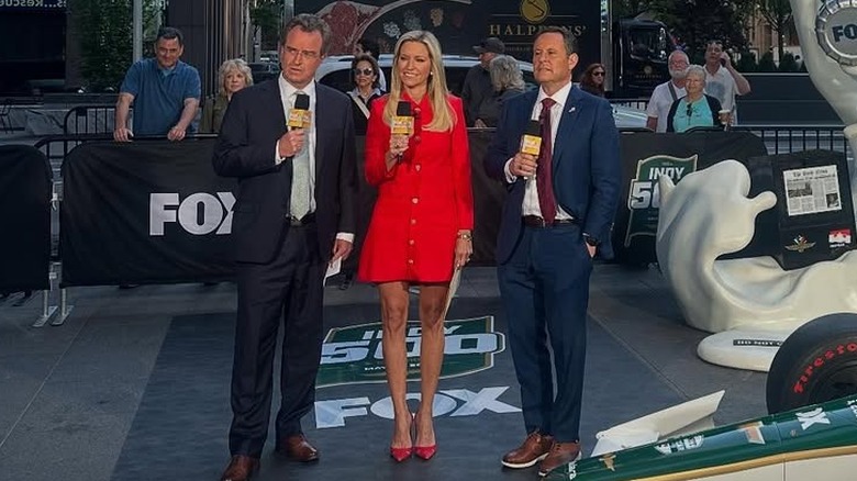 Ainsley Earhardt wearing a red dress while reporting from Fox Square