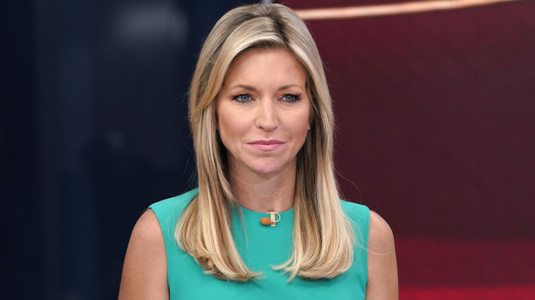 Ainsley Earhardt conducting an interview in a green dress