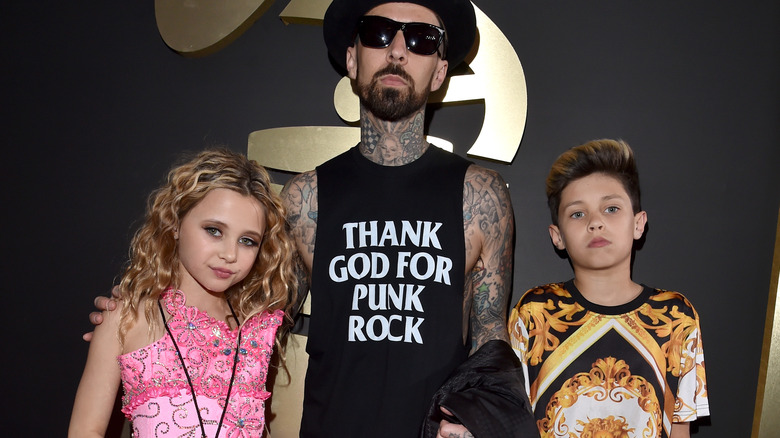 Alabama Barker posing with Travis and Landon Barker