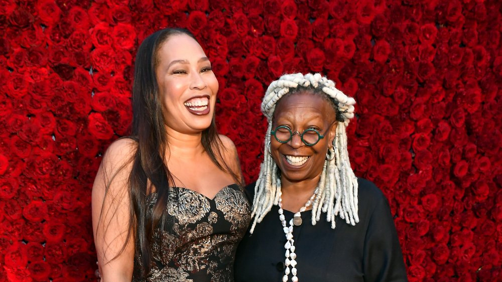 Whoopi Goldberg and daughter Alex Martin pose on a red carpet
