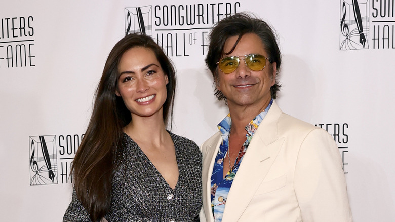 Caitlin McHugh and John Stamos smiling at the Songwriters Hall Of Fame