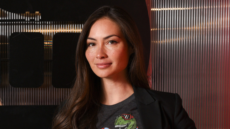 Caitlin McHugh in a dark tee in mood lighting