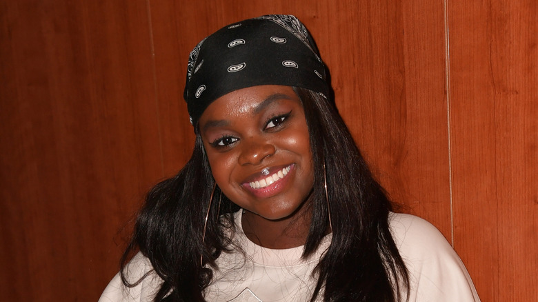 Cori Broadus smiling wearing a black bandana