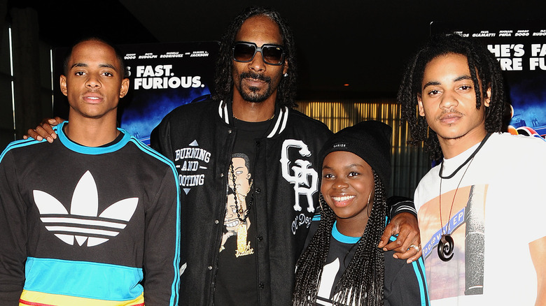 Snoop Dogg and his children Cordell Broadus, Cori Broadus, and Corde Broadus at an event