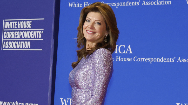 Norah O'Donnell smiling while posing in a sparkly dress at the 2026 White House Correspondents' Dinner