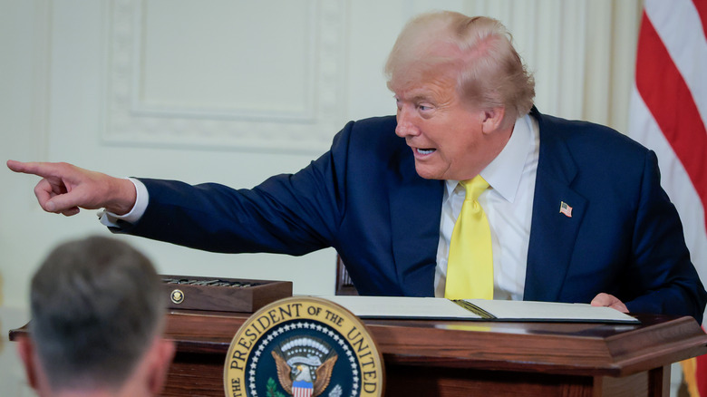 Donald Trump pointing while signing a proclamation
