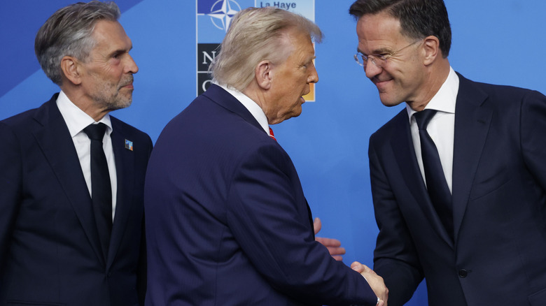 Donald Trump shaking hands onstage at the NATO summit