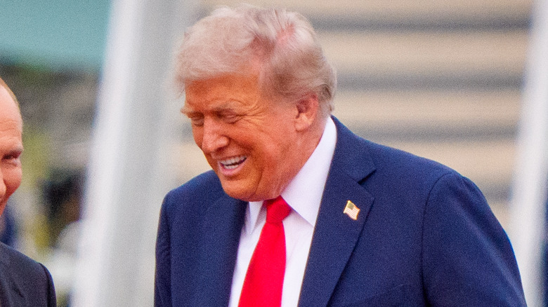 Donald Trump laughing alongside Vladimir Putin