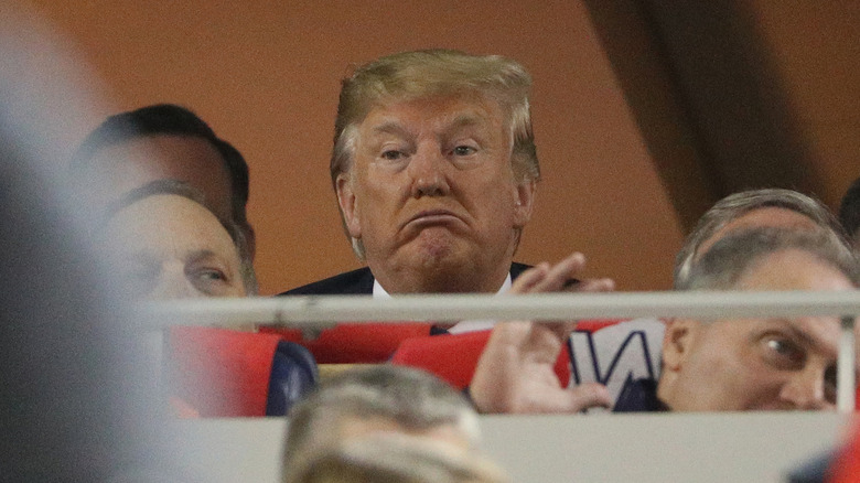 Donald Trump frowns while he gets booed at Game Five of the 2019 World Series between the Houston Astros and the Washington Nationals at Nationals Park on October 27, 2019.