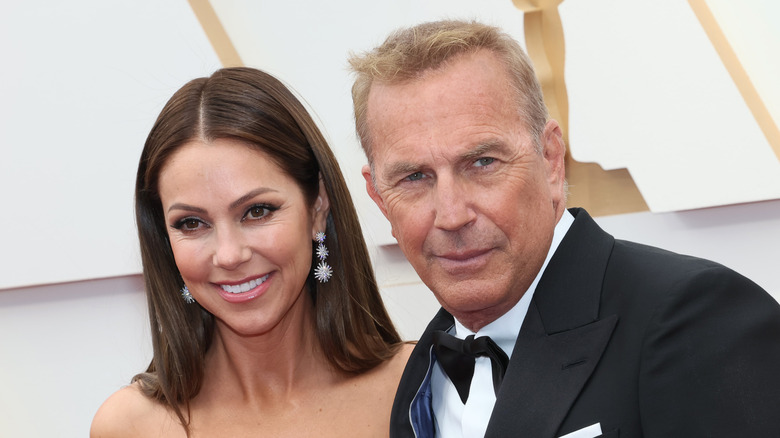 Christine Baumgartner smiling Kevin Costner black tuxedo
