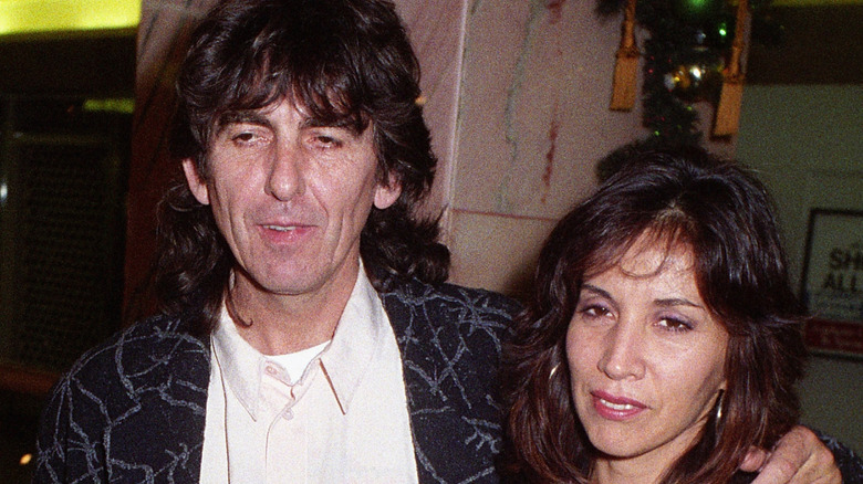 George and Olivia Harrison posing for cameras in London 1961