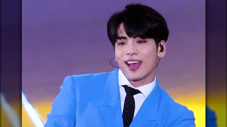 Jonghyun singing in a blue suit
