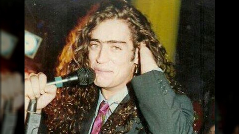 Rodrigo Bueno smiling with microphone in 1991