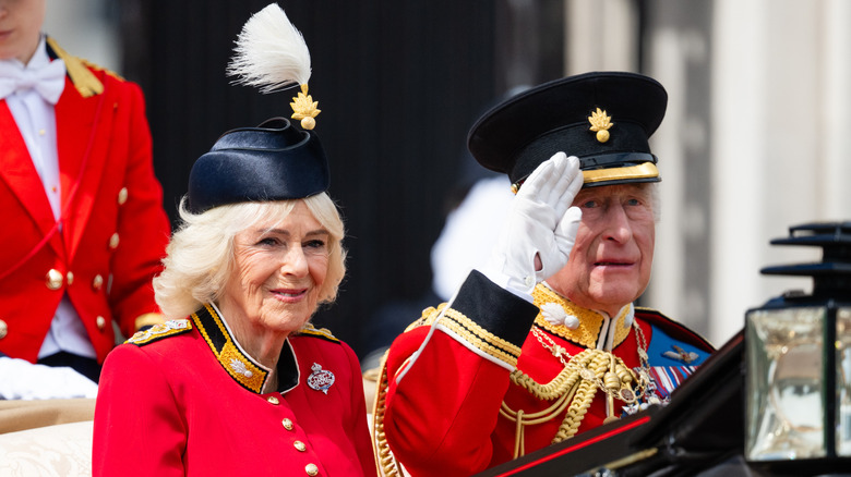 Queen Camilla and King Charles III ride in a carriage during Trooping the Colour 2026.