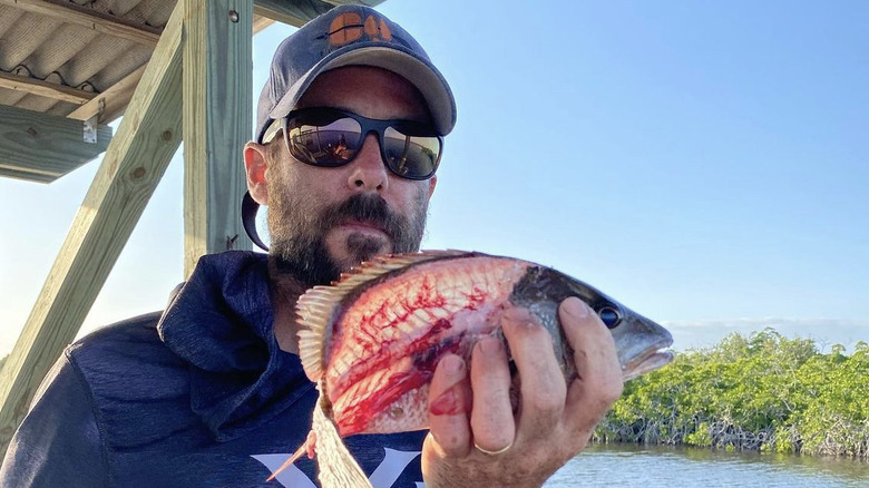 Clay Hayes posing with fish