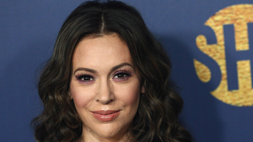 Alyssa Milano smiles for a photo on the red carpet