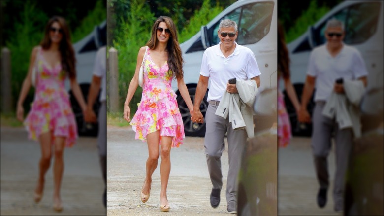 Amal and George strolling hand in hand