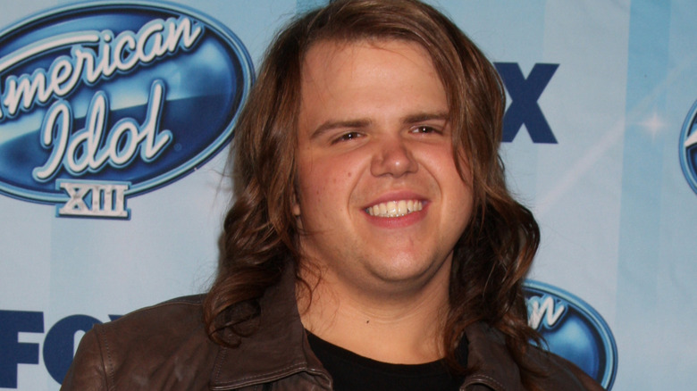 Caleb Johnson smiling for photographers at the American Idol season 13 finale in Los Angeles in May 2014